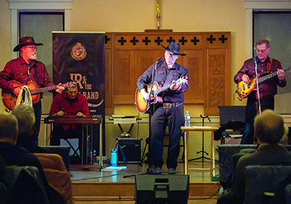 The four musicians of JR and the Bad Ox Band on stage